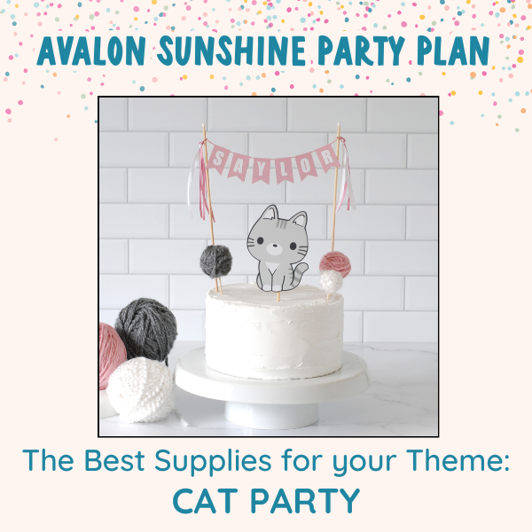 White birthday cake with a pink name banner and a grey cat topper with little yarn ball decorations | personalized cake toppers by Avalon Sunshine