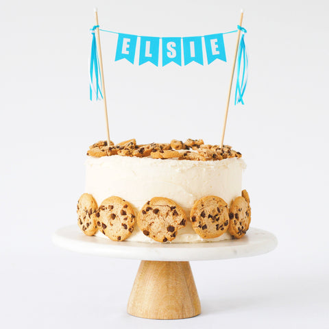 personalized name cake topper on a chocolate chip cookie cake