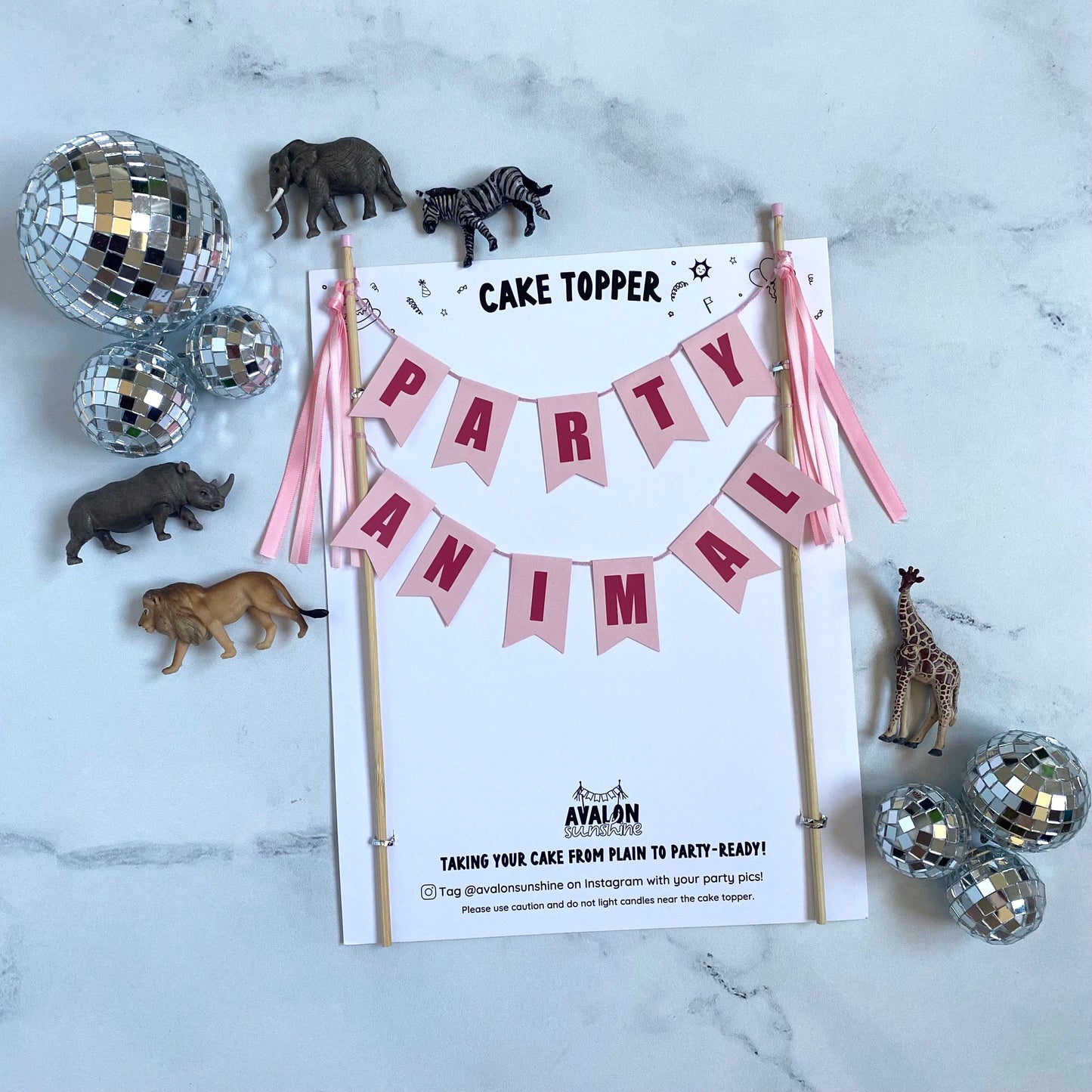 party animal birthday cake topper in pink shown with toy animals and disco balls | personalized cake toppers by Avalon Sunshine