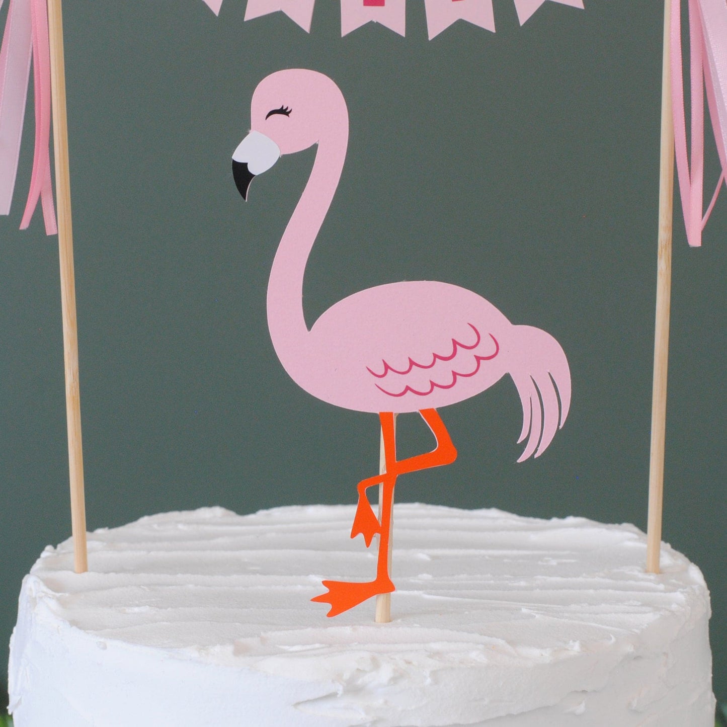 close up view of pink flamingo cake topper on a bamboo stick | cake toppers by Avalon Sunshine