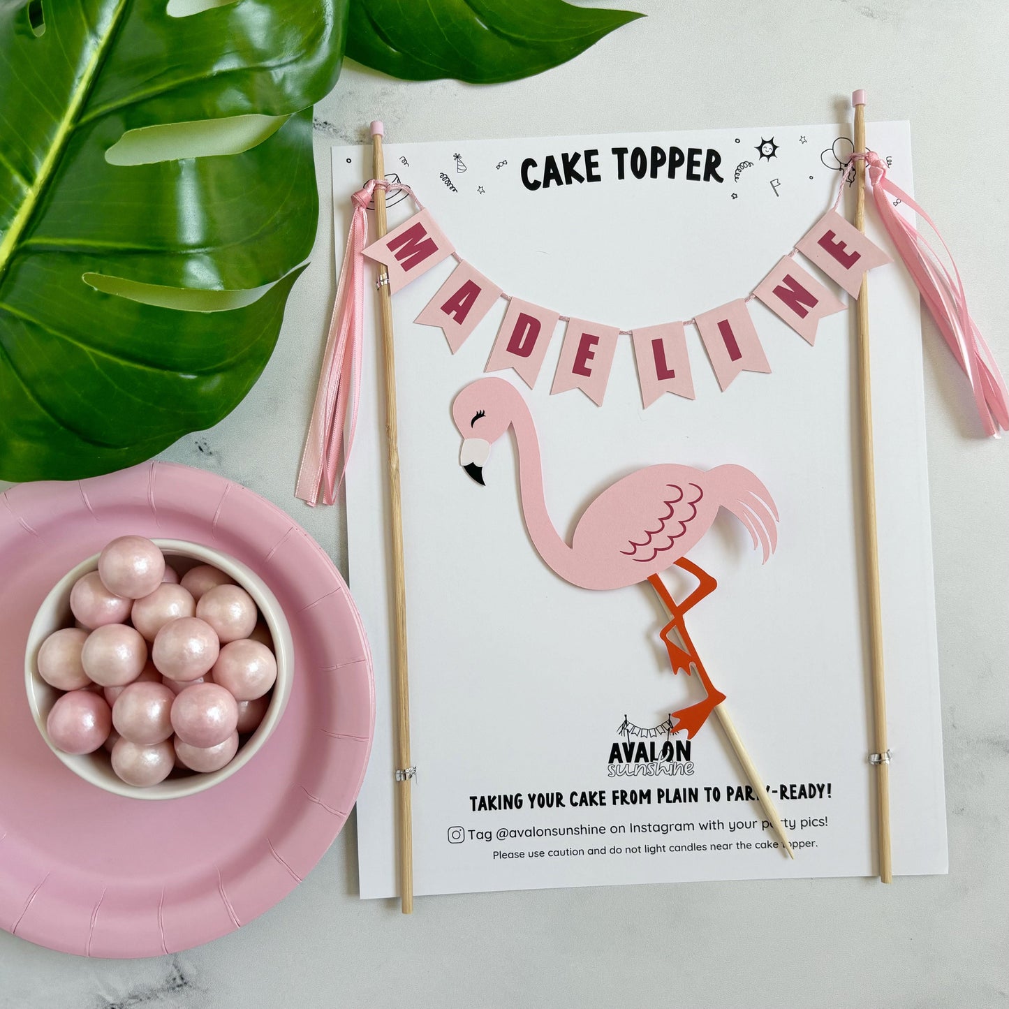 2 piece Flamingo theme birthday cake topper with name banner in shades of pink and a pink flamingo under the banner | personalized cake toppers by Avalon Sunshine