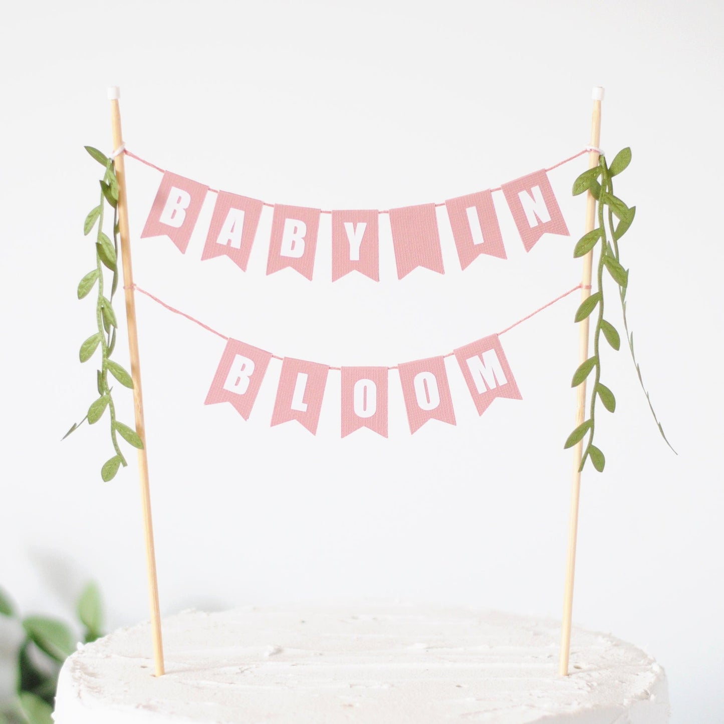 baby in bloom cake topper - two tiered dusty rose pink paper flags with leafy ribbon tassels