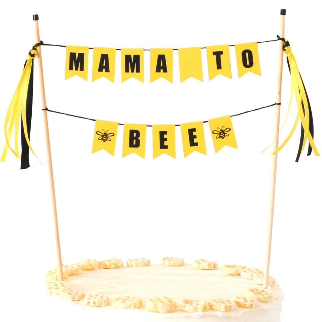 yellow and black cake banner with wording "mama to bee" for a bee themed baby shower