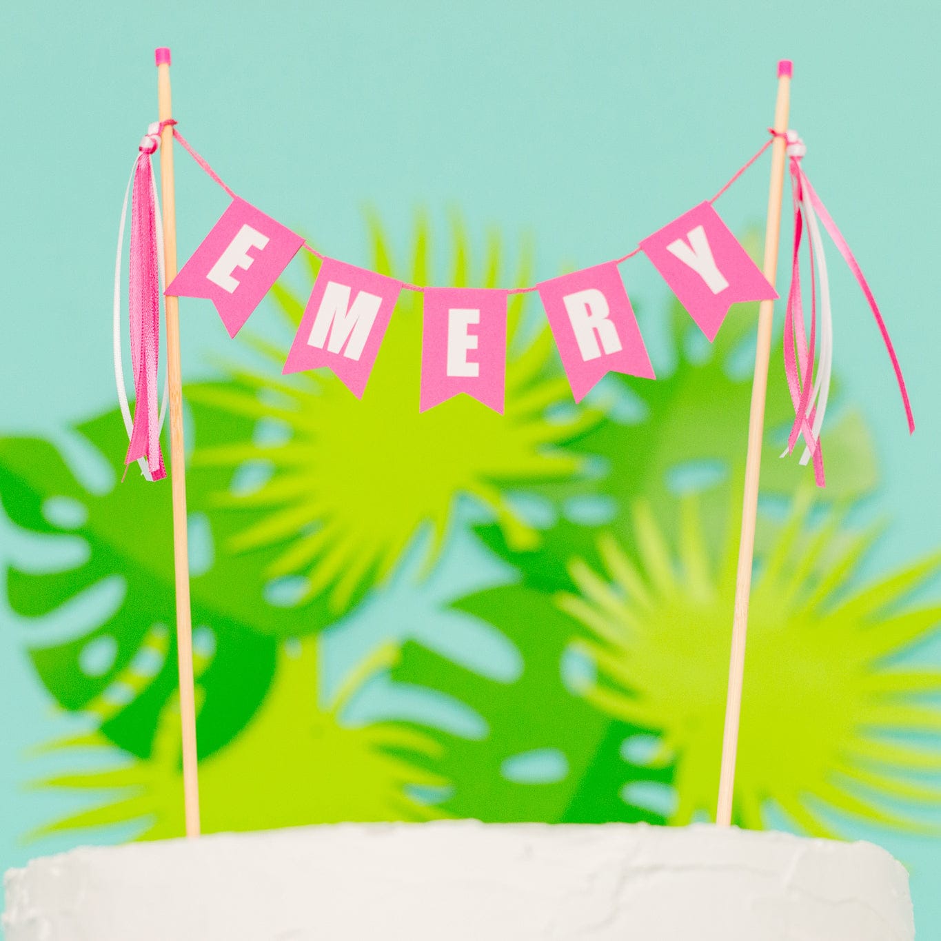 bright pink birthday cake topper for girls, banner personalized with first name and ribbon tassles
