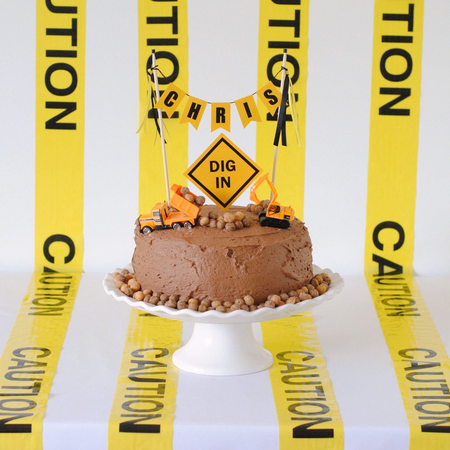 construction theme birthday cake topper with toy trucks, cake topper set and caution tape decorations