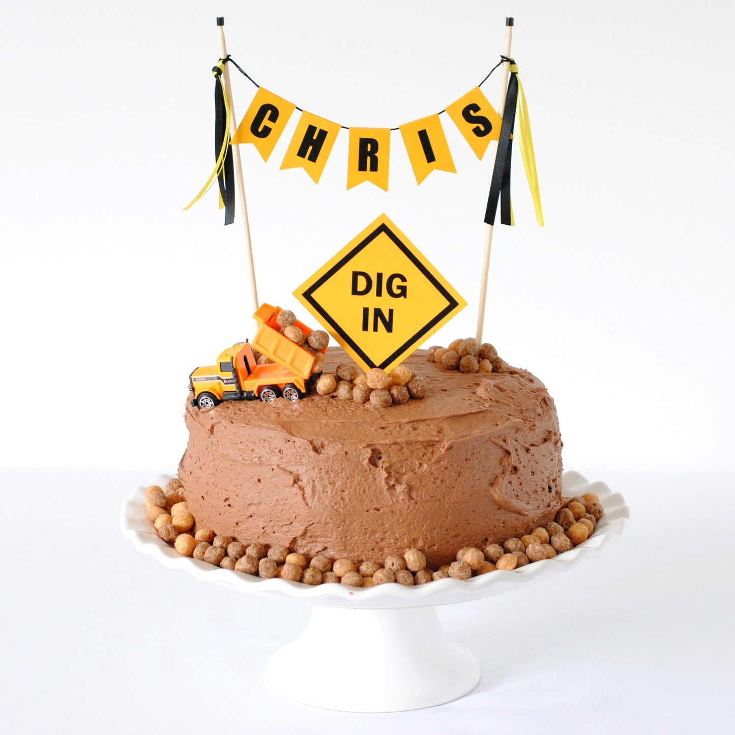 
                  
                    chocolate cake  with toy dump truck for construction theme party with yellow and black construction sign cake topper
                  
                