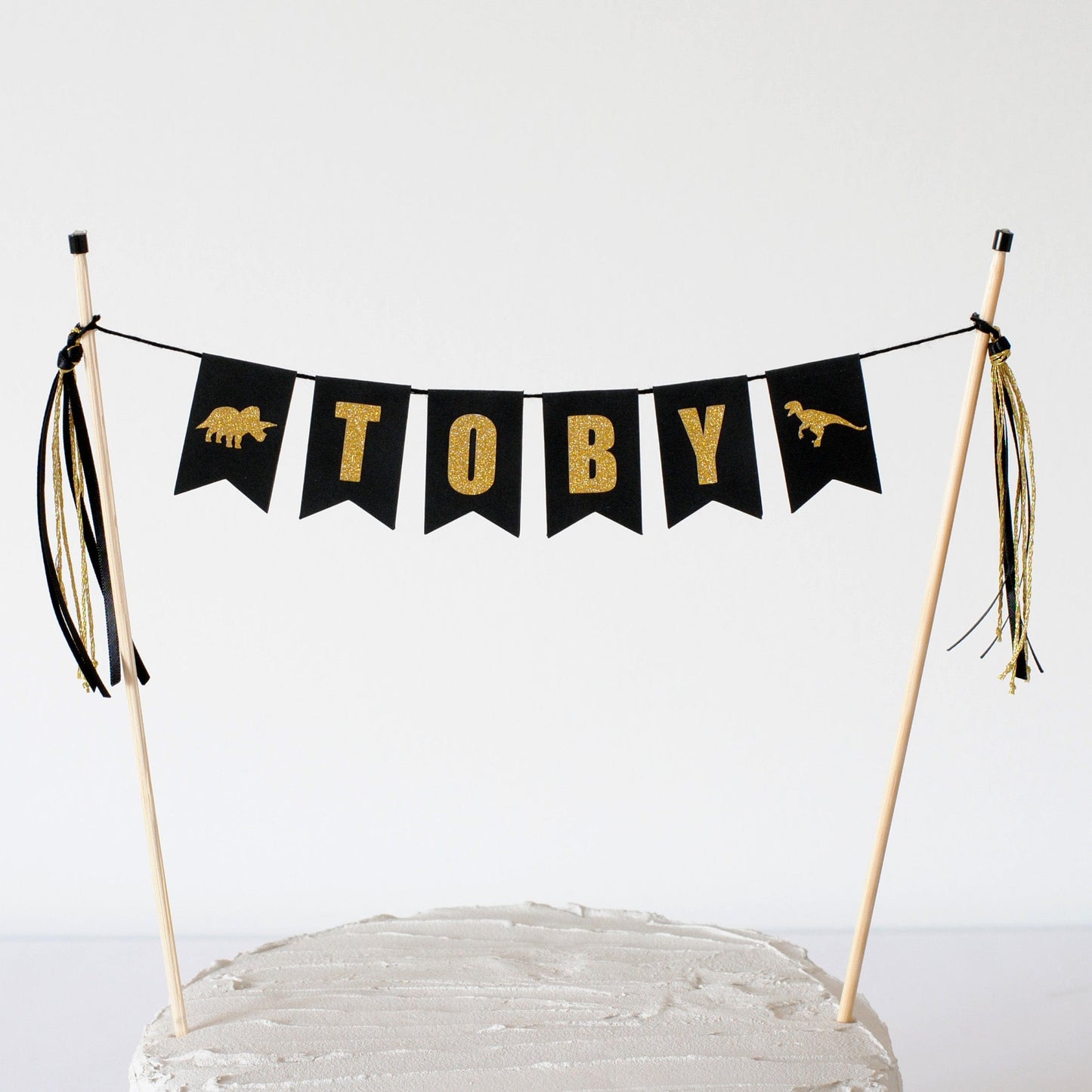 dinosaur theme cake topper name banner with black and gold letters