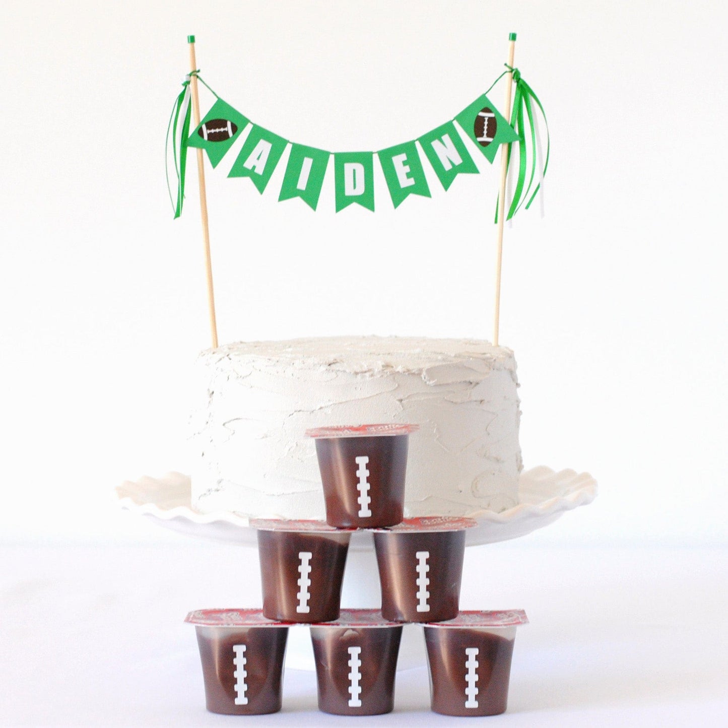 football cake topper with name banner and little footballs