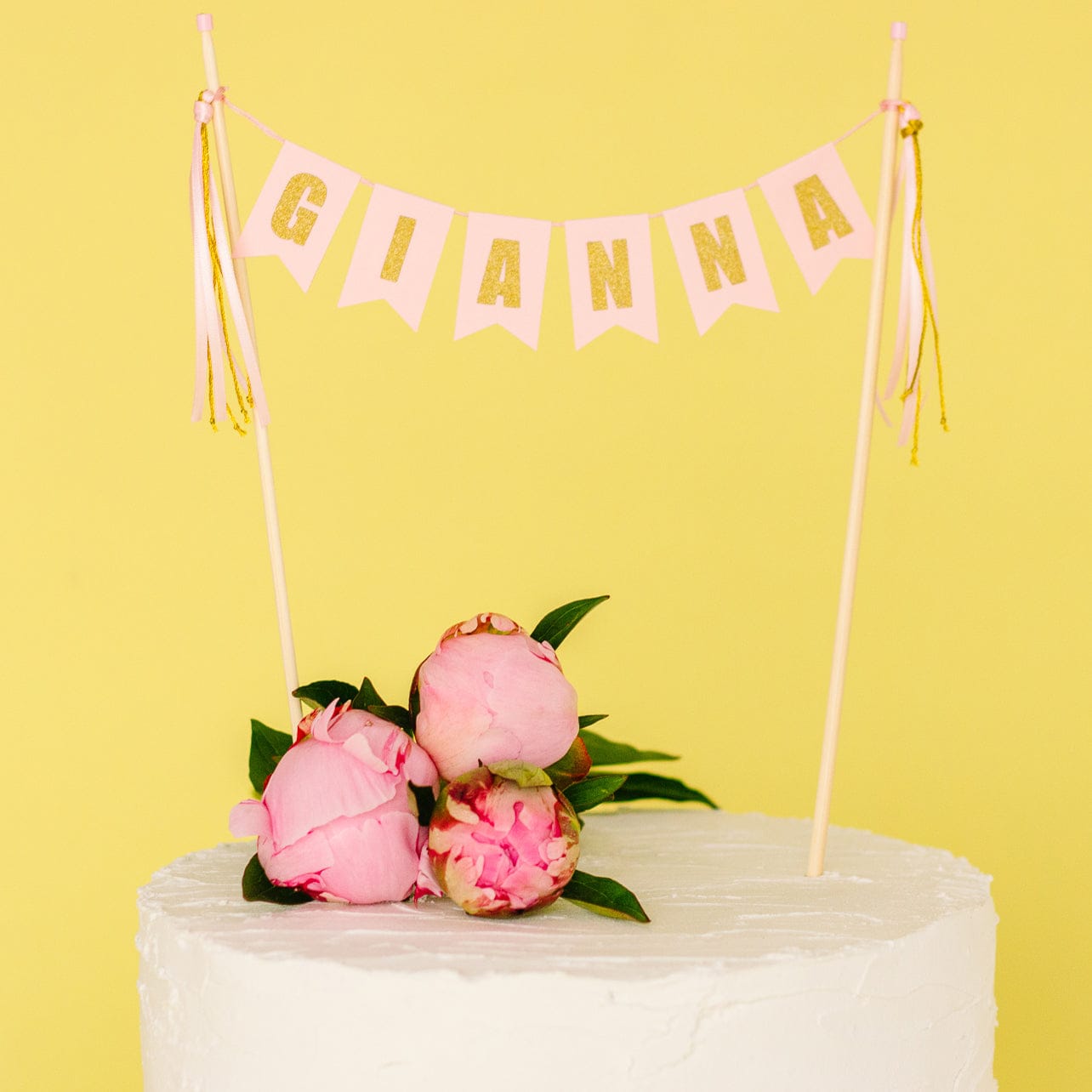 girls birthday cake topper name banner in light pink with gold glitter letters