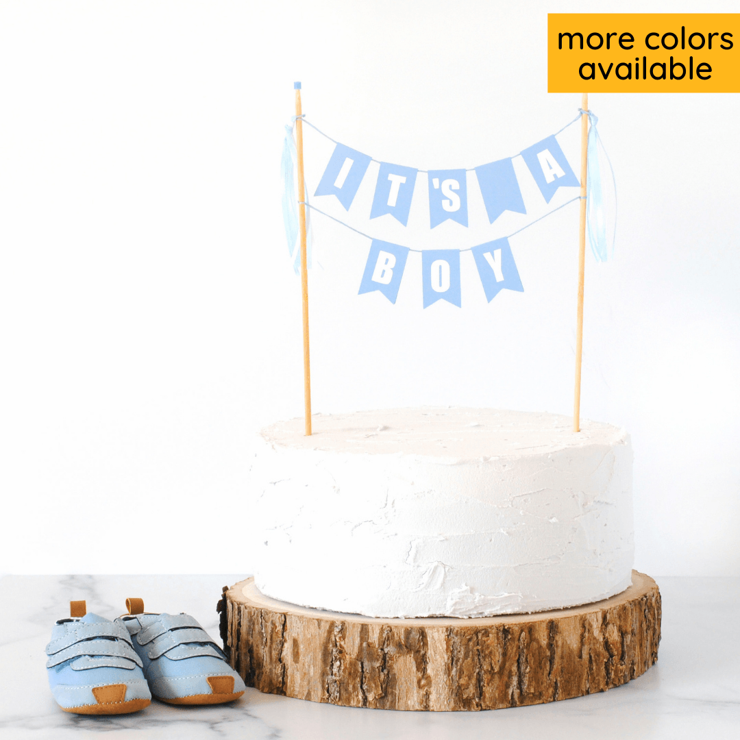 two tier cake topper in light blue with words "it's a boy"