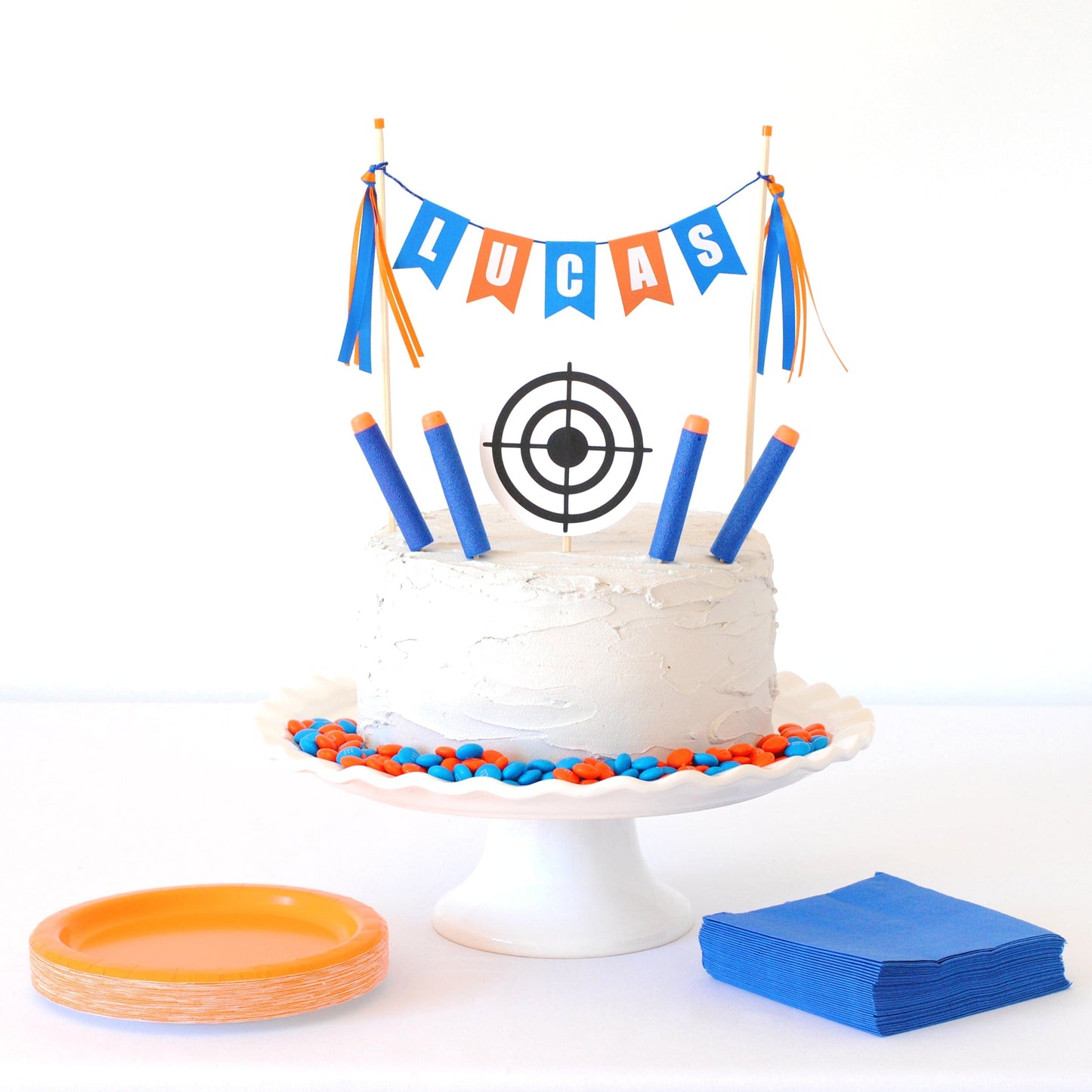 orange and blue personalized name cake topper with round target and nerf-style foam darts