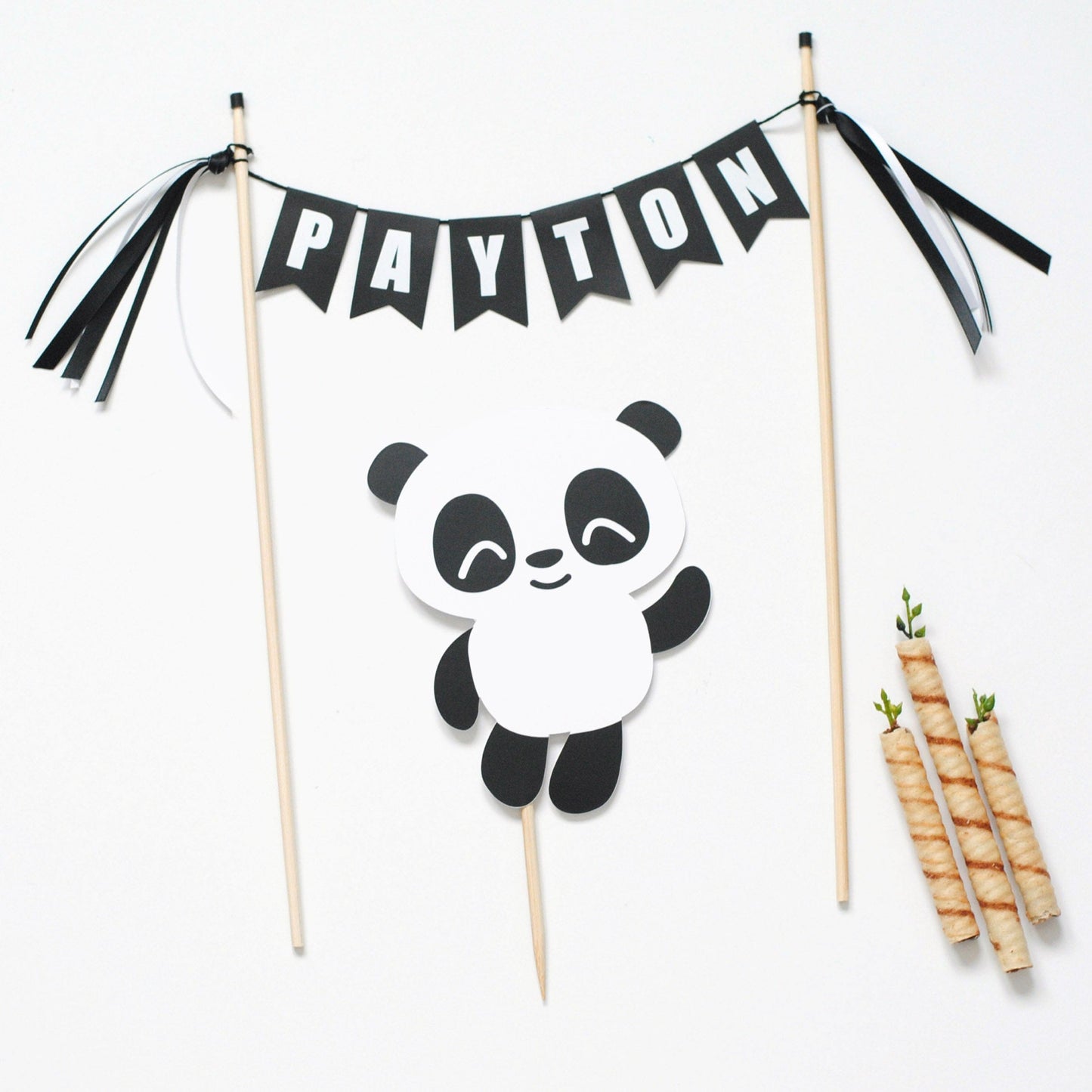 Panda birthday cake topper with black and white name banner and a paper panda