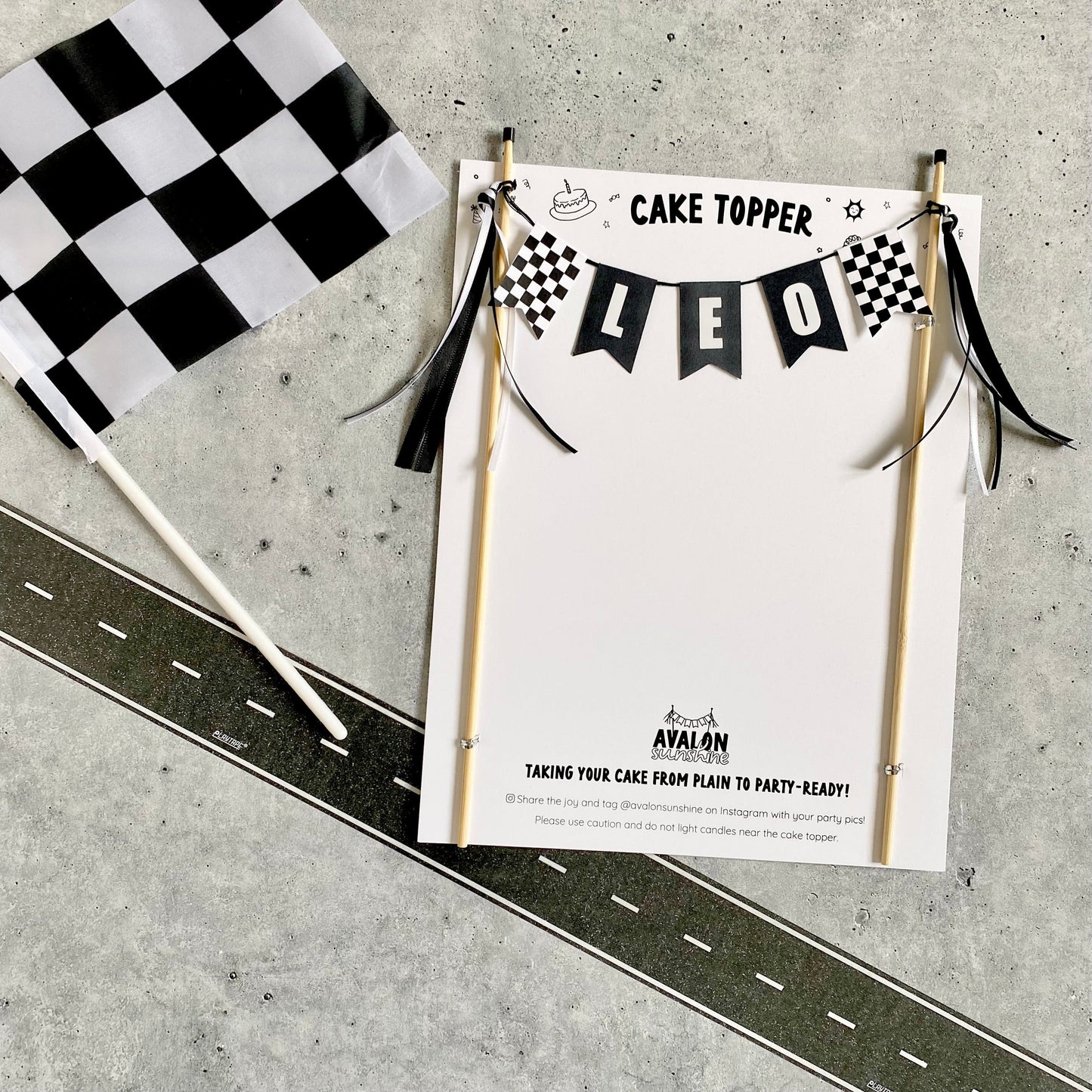 black and white racing theme birthday party cake topper with name and checkered flags