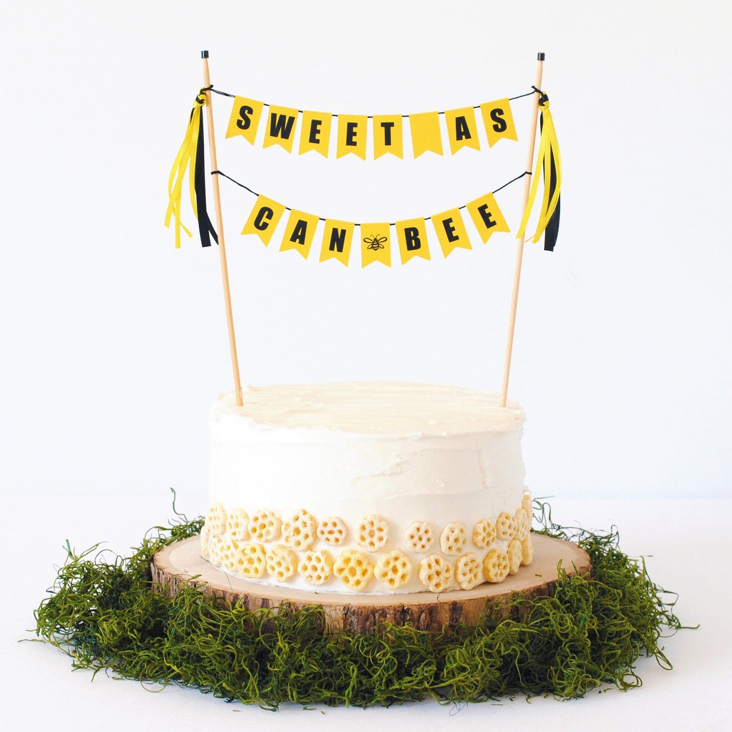 SWEET AS CAN BEE cake topper shown on a cake with Honeycomb cereal decorations