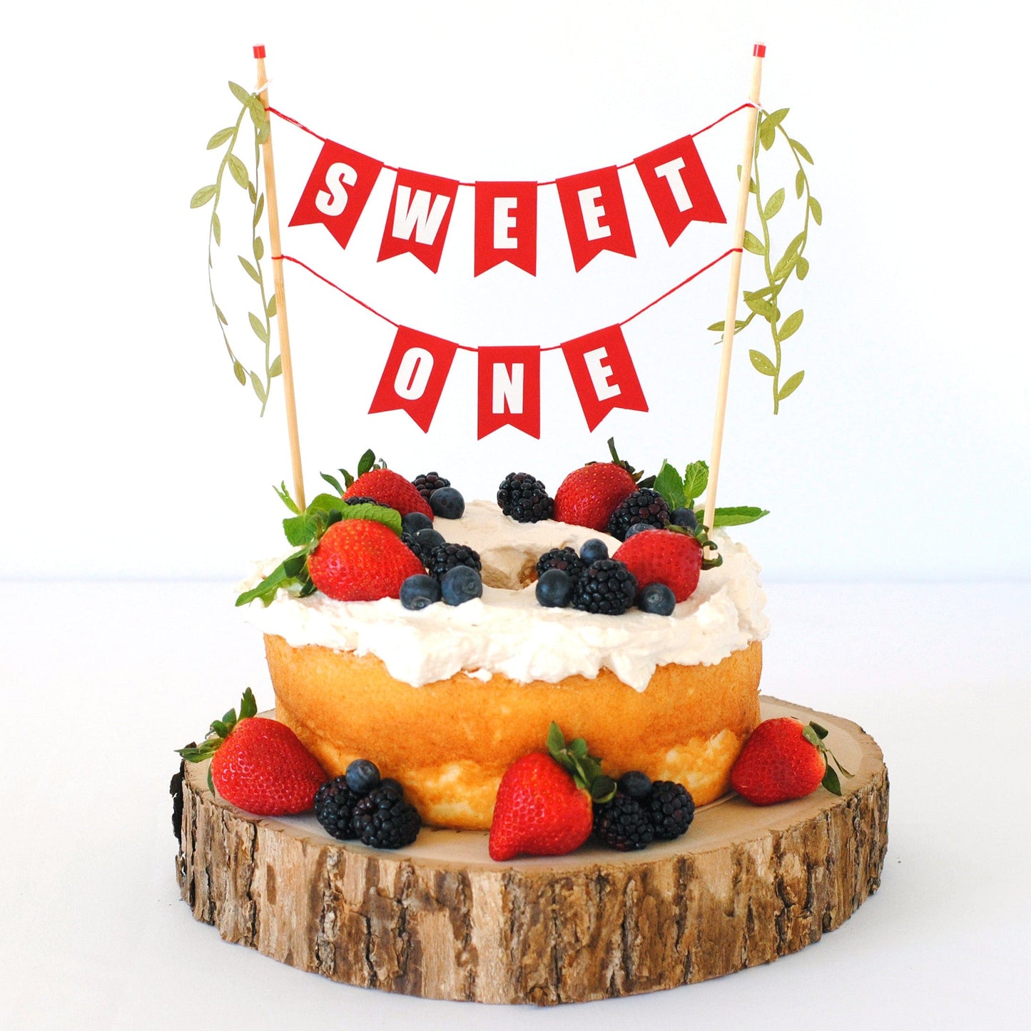 SWEET ONE 1st birthday cake topper shown on angel food cake topped with fresh berries | cake topper made by Avalon Sunshine