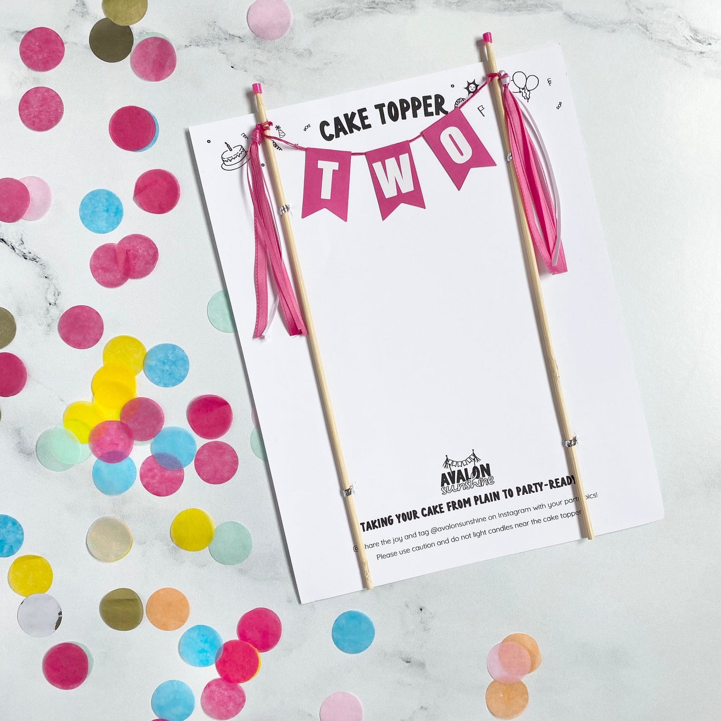 bright pink cake banner for second birthday day. wording: TWO