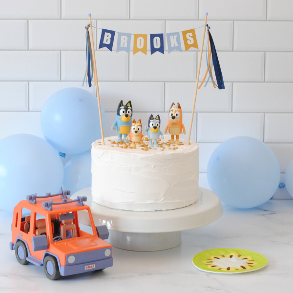 Bluey Birthday Cake Idea with personalized cake topper and Blue figures on top