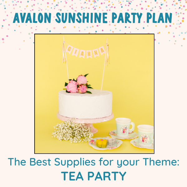 White birthday cake with pink flowers on top and a Pink Name banner with gold letters.  There are flowers and tea party supplies around the cake