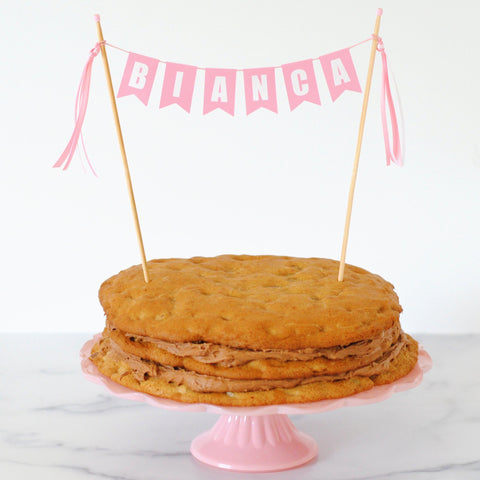 pink name cake topper for girls on a chocolate chip cookie birthday cake