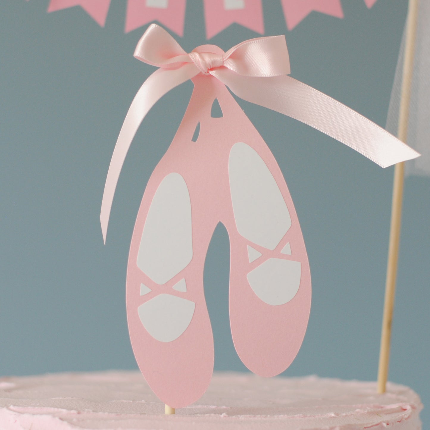 
                  
                    Pink ballet slipper cake topper with a bow on a gray background | cake toppers by Avalon Sunshine
                  
                