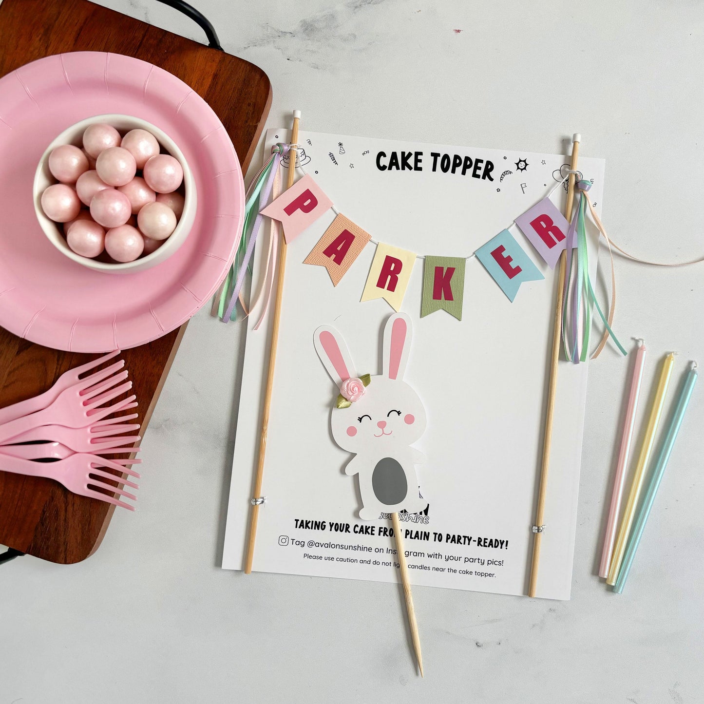 
                  
                    Bunny theme birthday cake topper 2 piece set.  Pastel rainbow name banner and white bunny with a pink flower by its ear | personalized cake toppers by Avalon Sunshine
                  
                