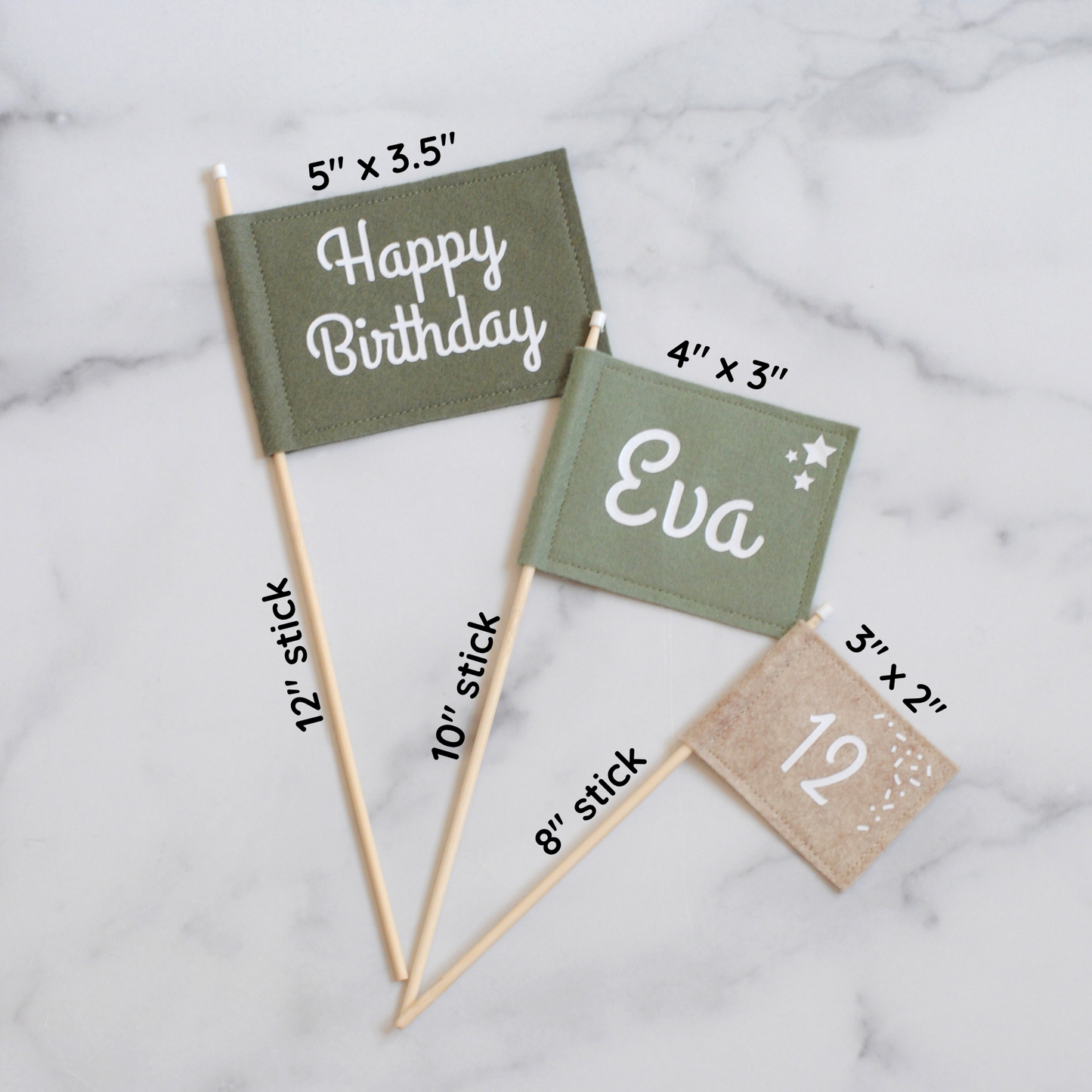 
                  
                    Set of 3 felt flag birthday cake toppers in earthy green and beige colors.  Big flag has HAPPY BIRTHDAY, medium flag is personlized with name EVA, and small flag has age: 12. Shown flag with measurements of each stick and flag. 
                  
                