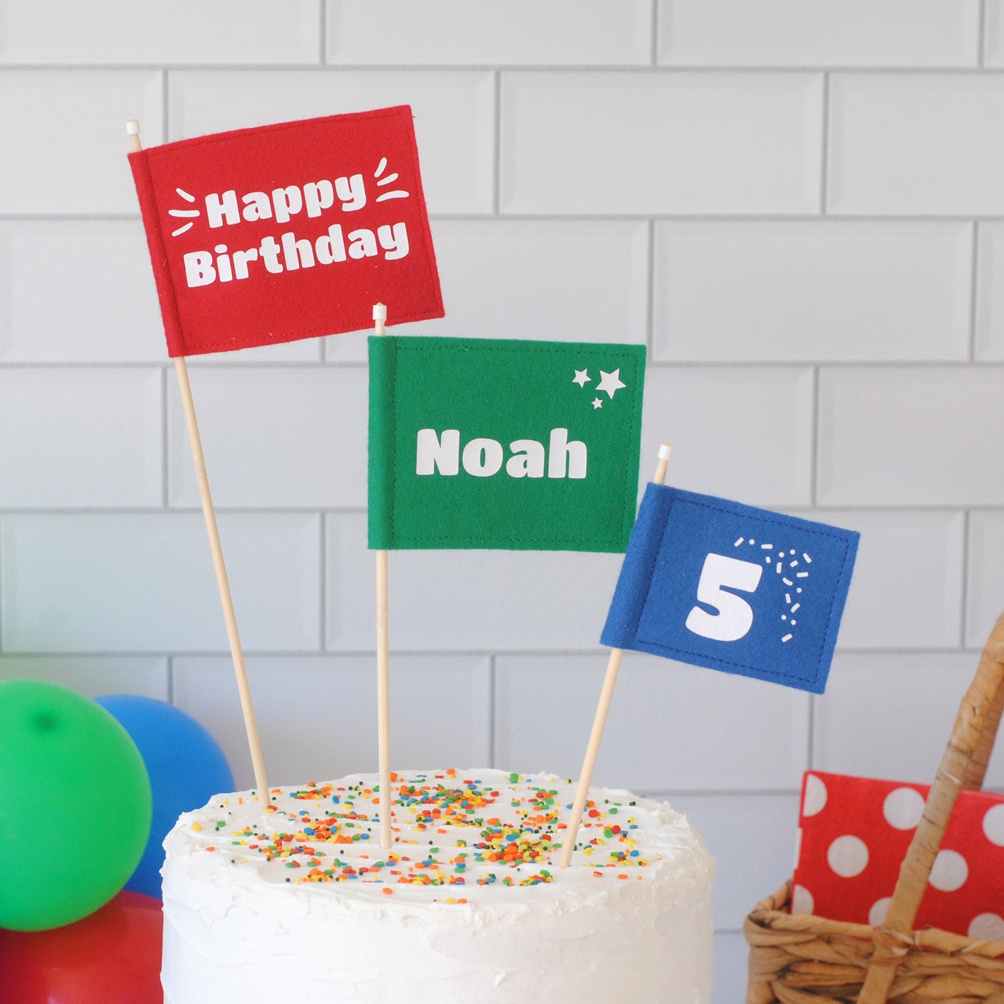 felt flag cake topper set with 3 flags: red with HAPPY BIRTHDAY, green personalized with NAME, and blue personalized wth AGE.