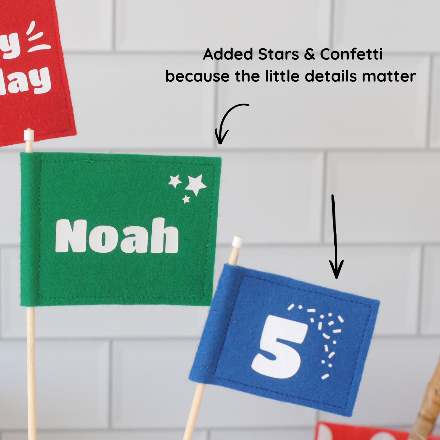 
                  
                    close-up details of felt flag cake toppers: stars on the corner of the name flag and confetti on the corner of the age flag.
                  
                