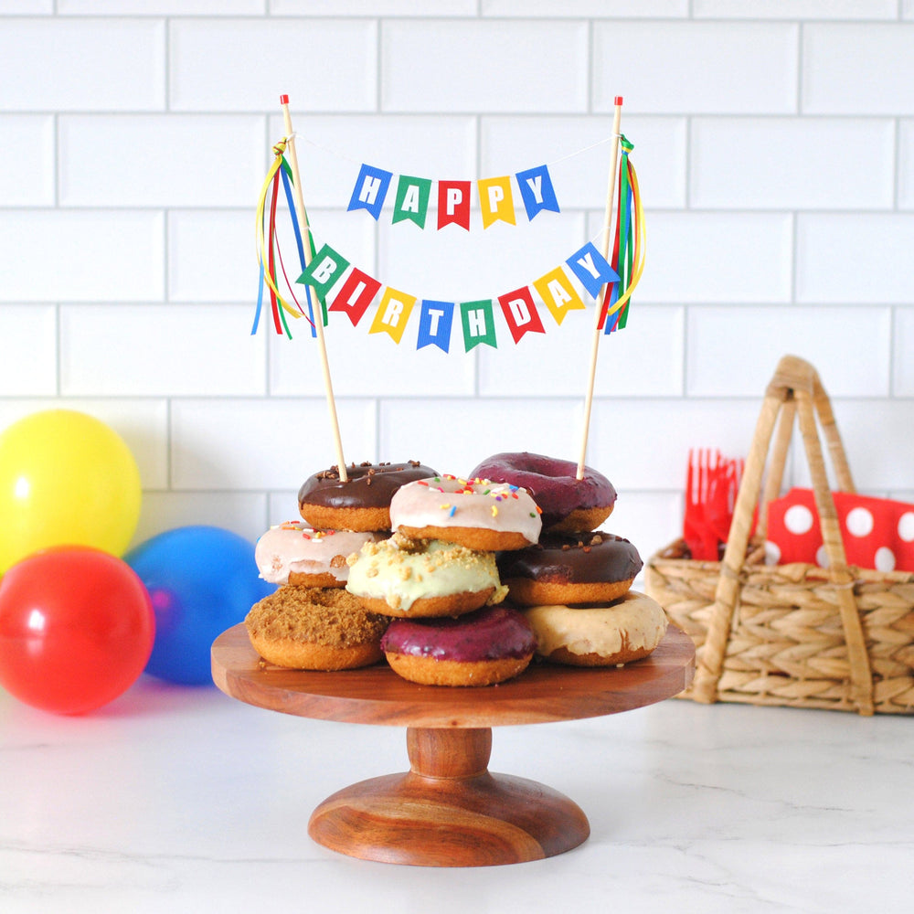 
                  
                    HAPPY BIRTHDAY cake topper in red, blue, green and yellow on a stack of donuts | cake topper by Avalon Sunshine
                  
                