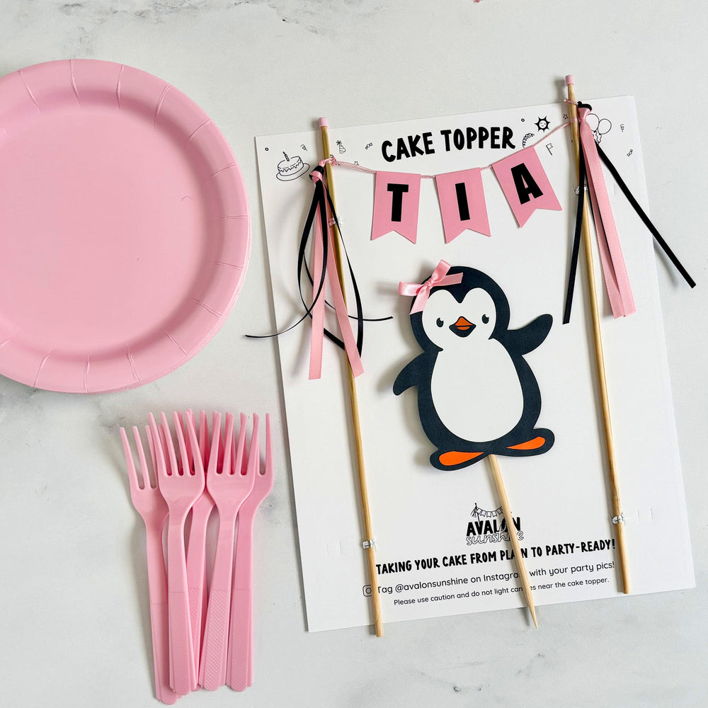 
                  
                    Penguin theme birthday cake topper for girls with personalized name banner and penguin with a pink bow | personalized cake toppers by Avalon Sunshine
                  
                