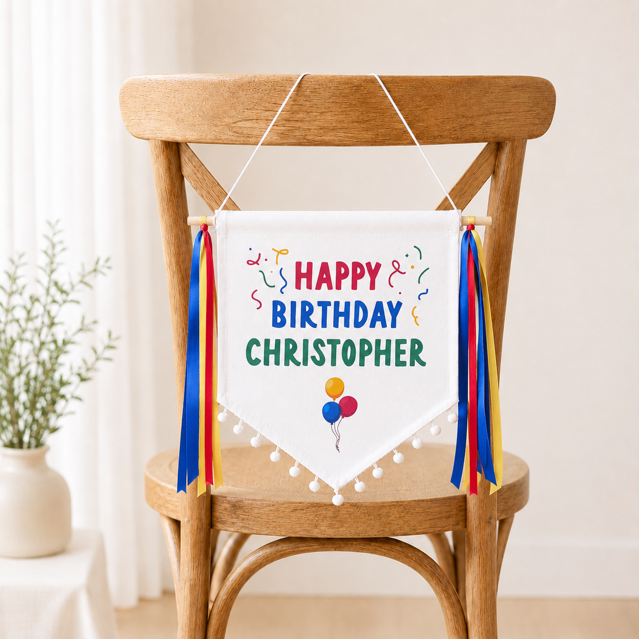 Personalized canvas banner with 'Happy Birthday Christopher' on a wooden chair