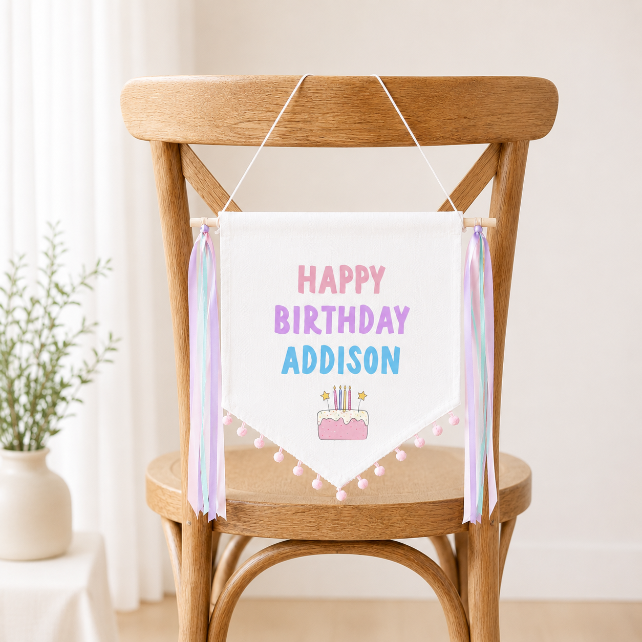 Birthday banner with 'Happy Birthday Addison' on a wooden chair