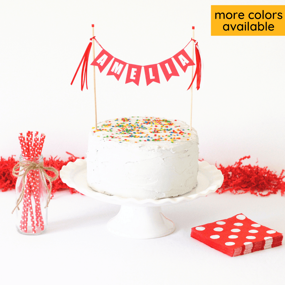personalized birthday cake topper for kids in red and white shown on a while cake with sprinkles