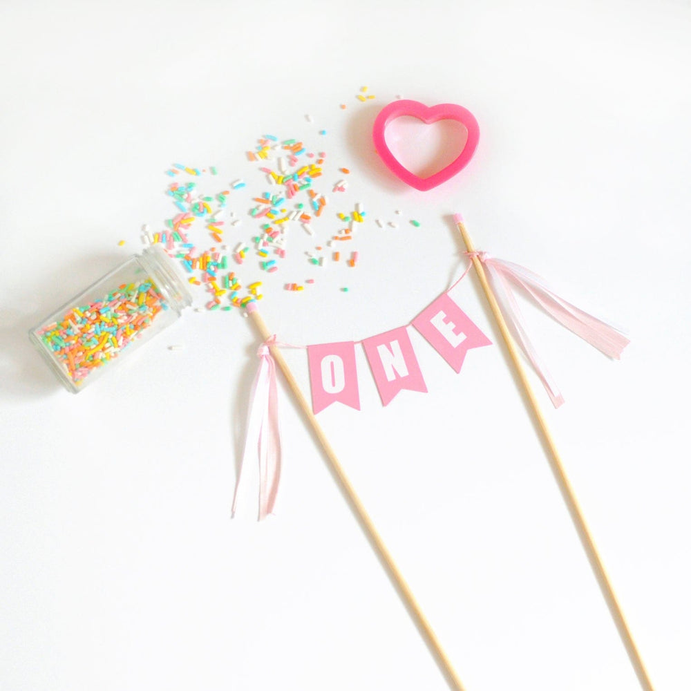 
                  
                    pastel pink ONE cake banner for girls first birthday cake
                  
                