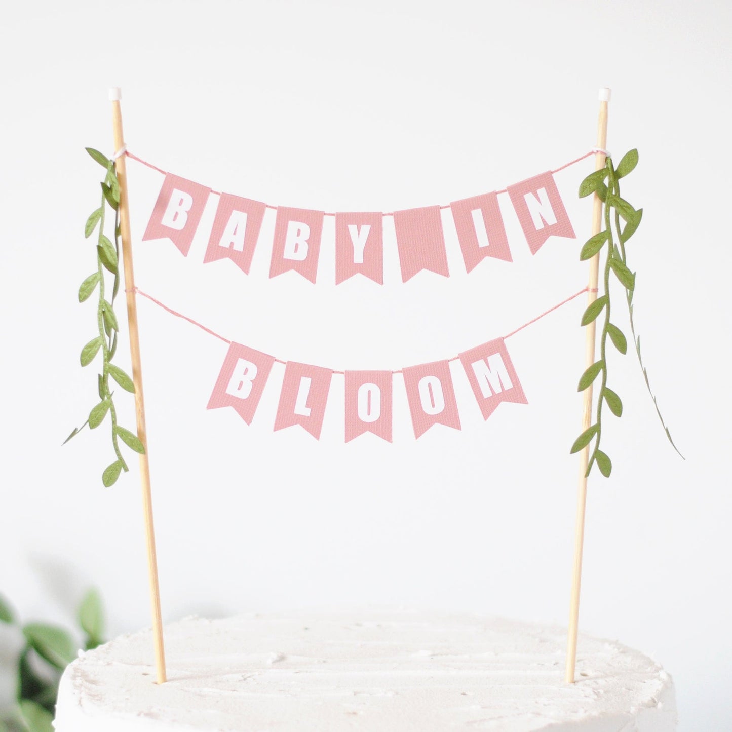 
                  
                    baby in bloom cake topper - two tiered dusty rose pink paper flags with leafy ribbon tassels
                  
                