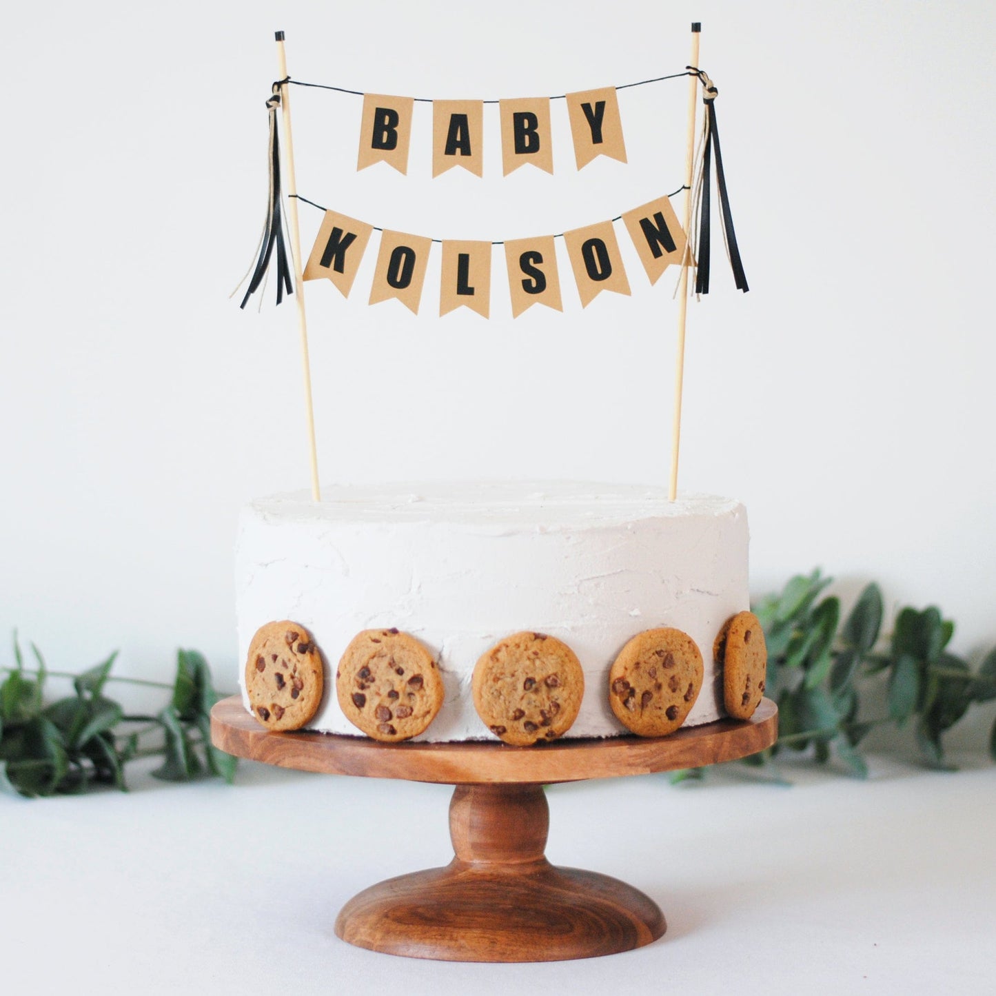 
                  
                    personalized baby shower cake topper with baby name - beige and black colors styled with chocolate chip cookie cake
                  
                