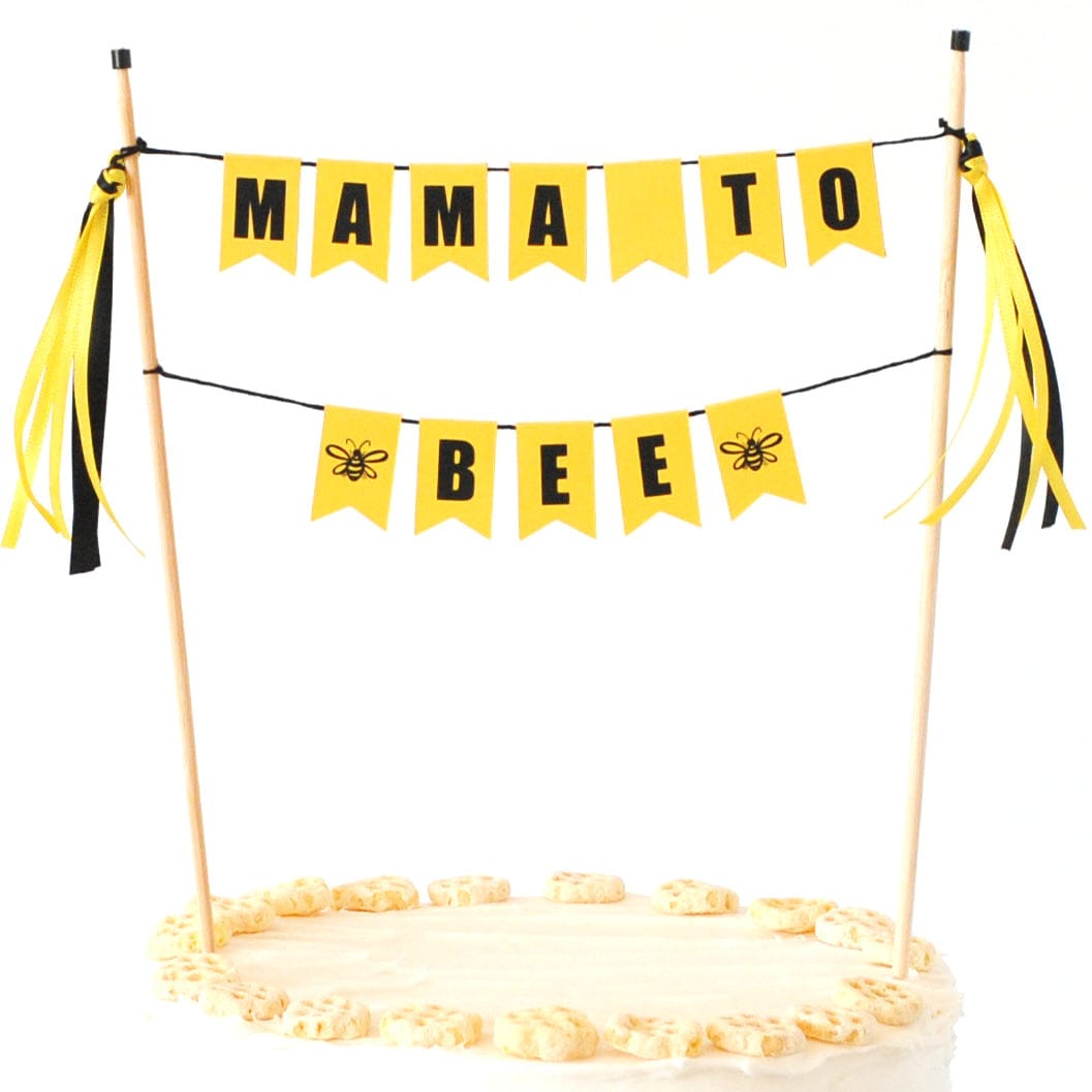 
                  
                    yellow and black cake banner with wording "mama to bee" for a bee themed baby shower
                  
                