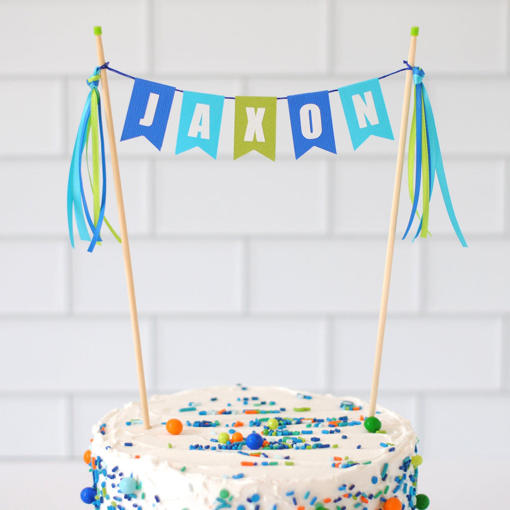 
                  
                    Kids personalized birthday cake topper in shades of blue and green | cake topper made by Avalon Sunshine
                  
                