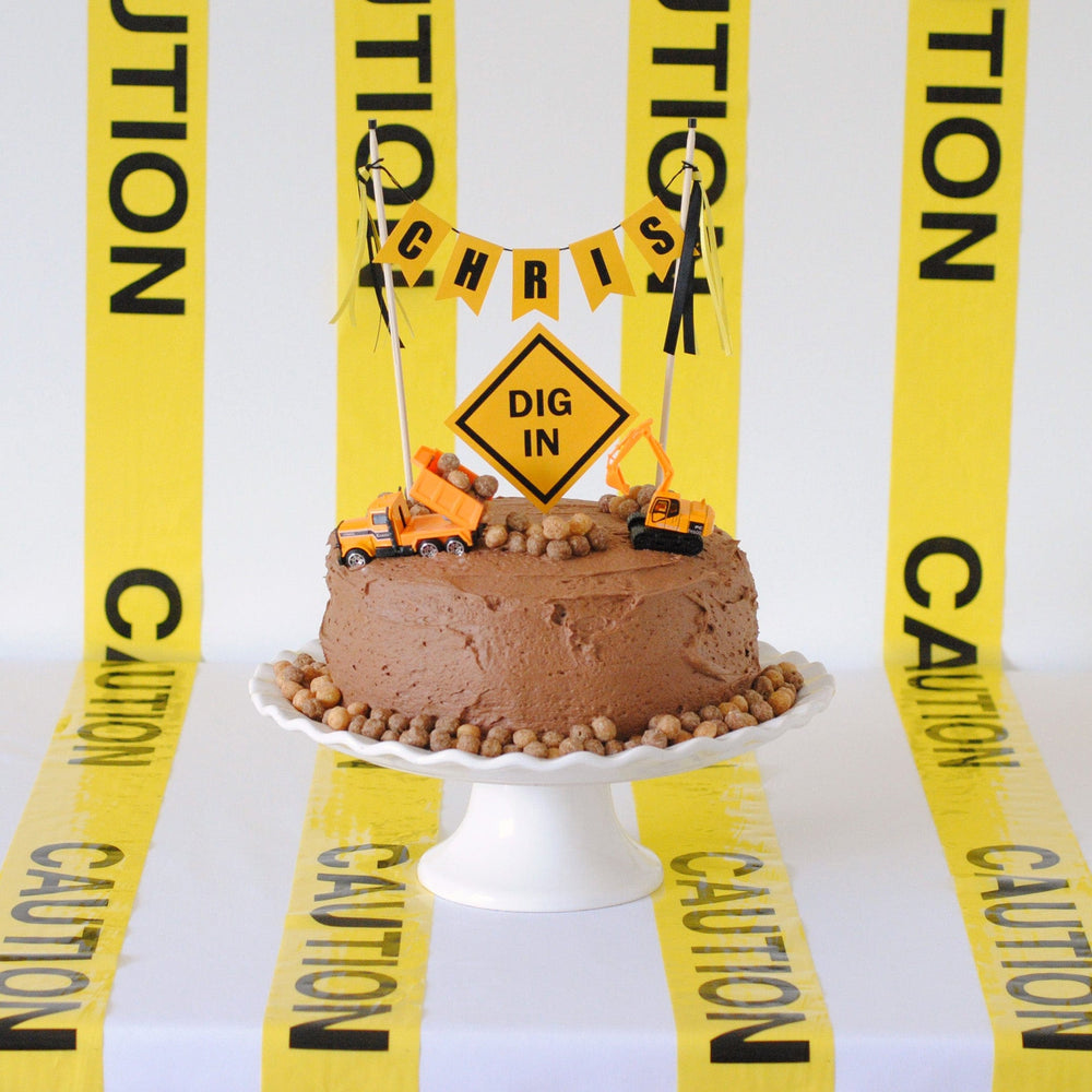 
                  
                    construction theme birthday cake topper with toy trucks, cake topper set and caution tape decorations
                  
                
