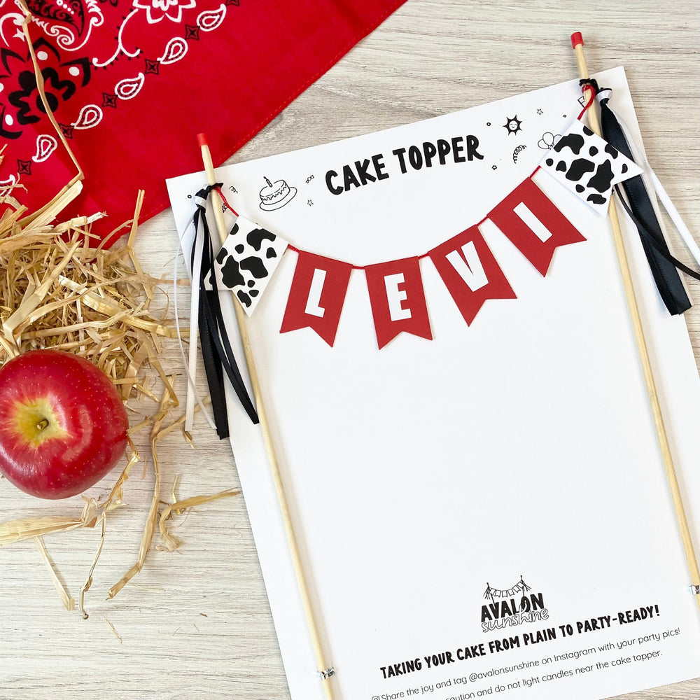 
                  
                    personalized farm theme cake banner with name on red flags and cow print flag on each end
                  
                