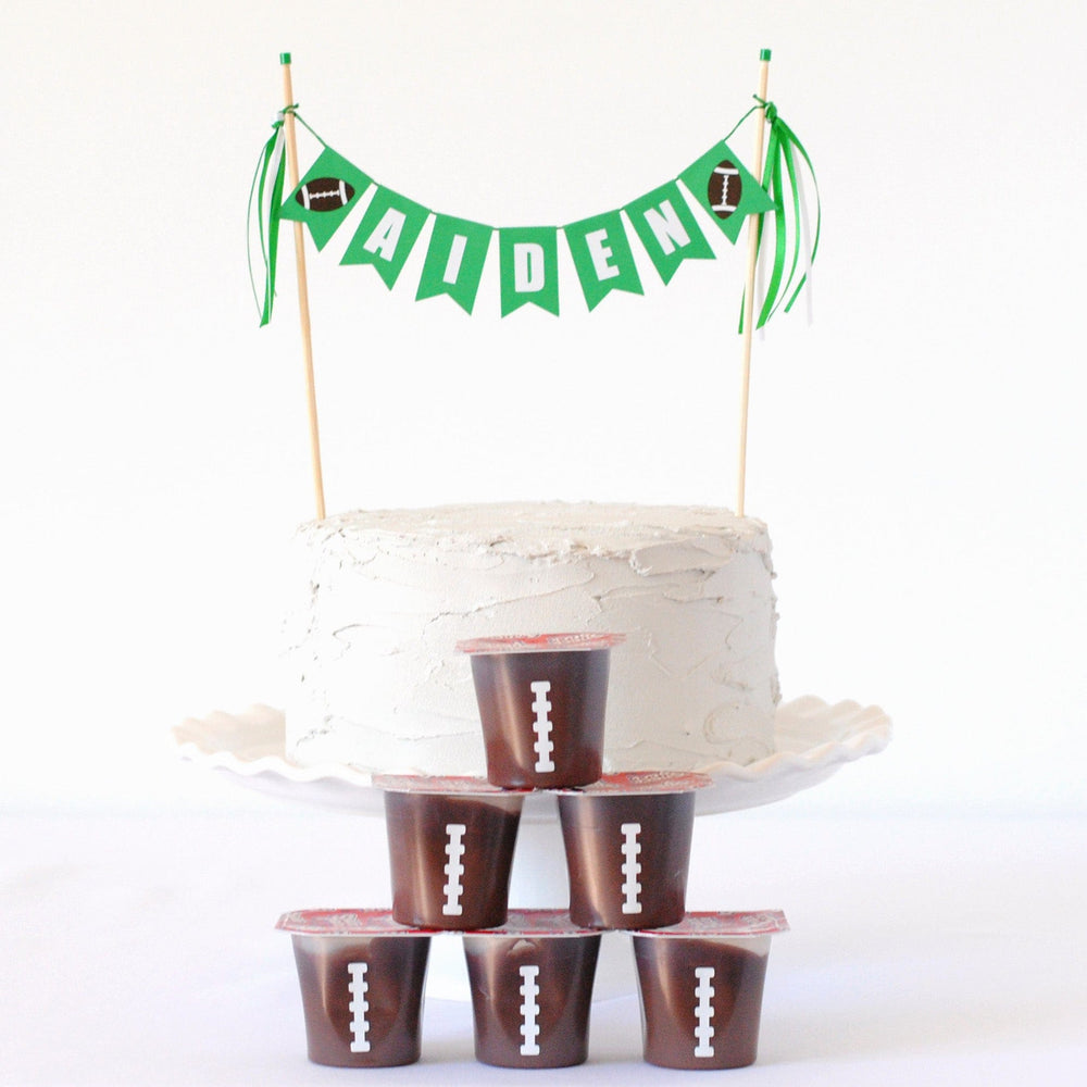 
                  
                    football cake topper with name banner and little footballs
                  
                