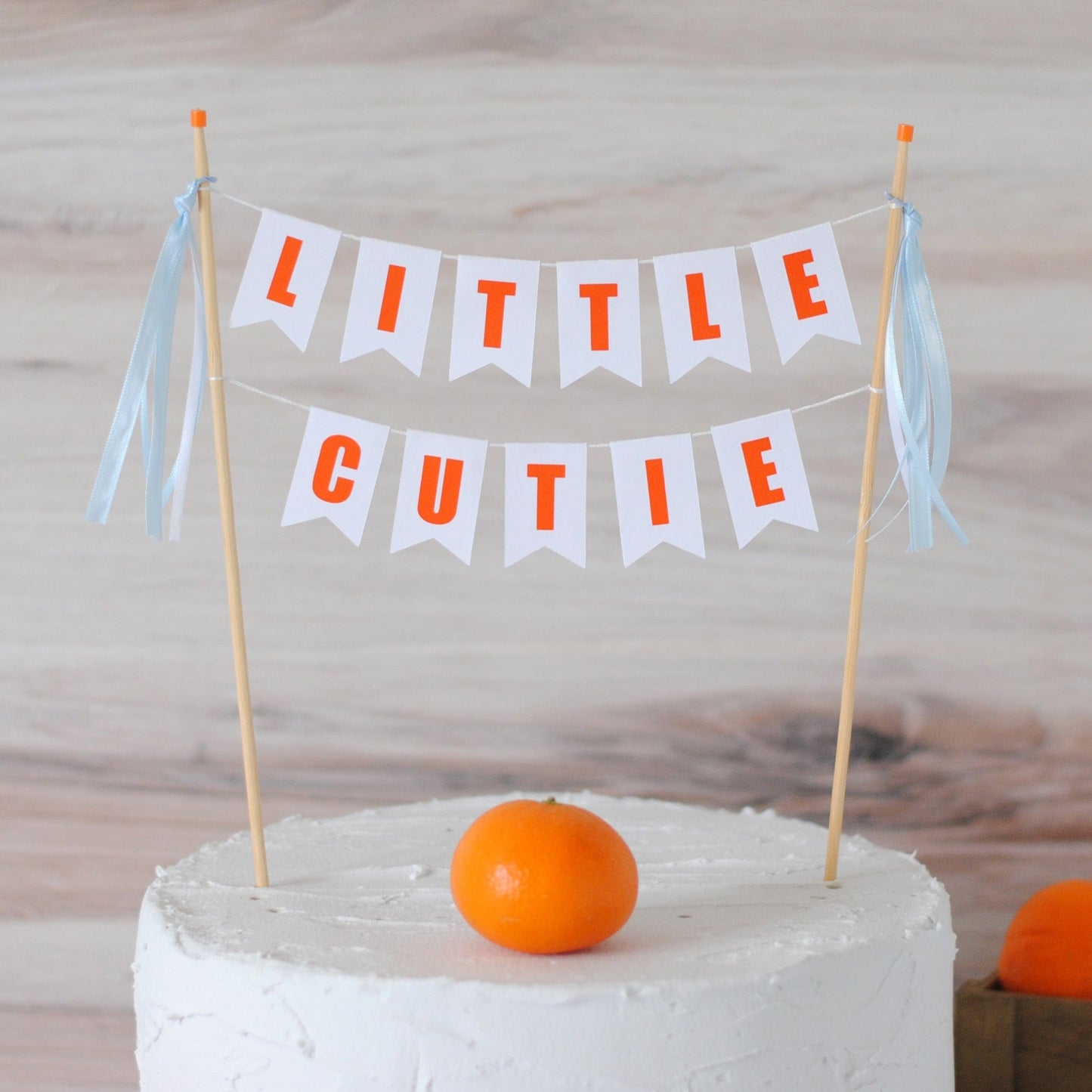 
                  
                    little cutie cake banner with blue ribbons for boys baby shower or birthday
                  
                