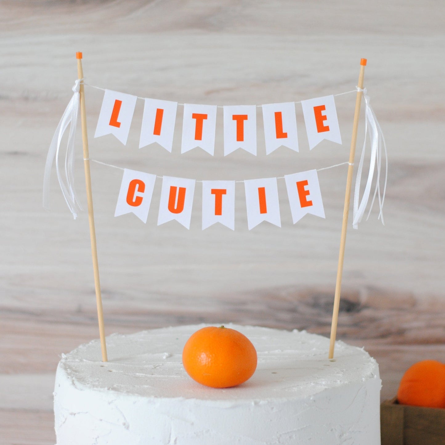 
                  
                    little cutie cake banner with white ribbons
                  
                