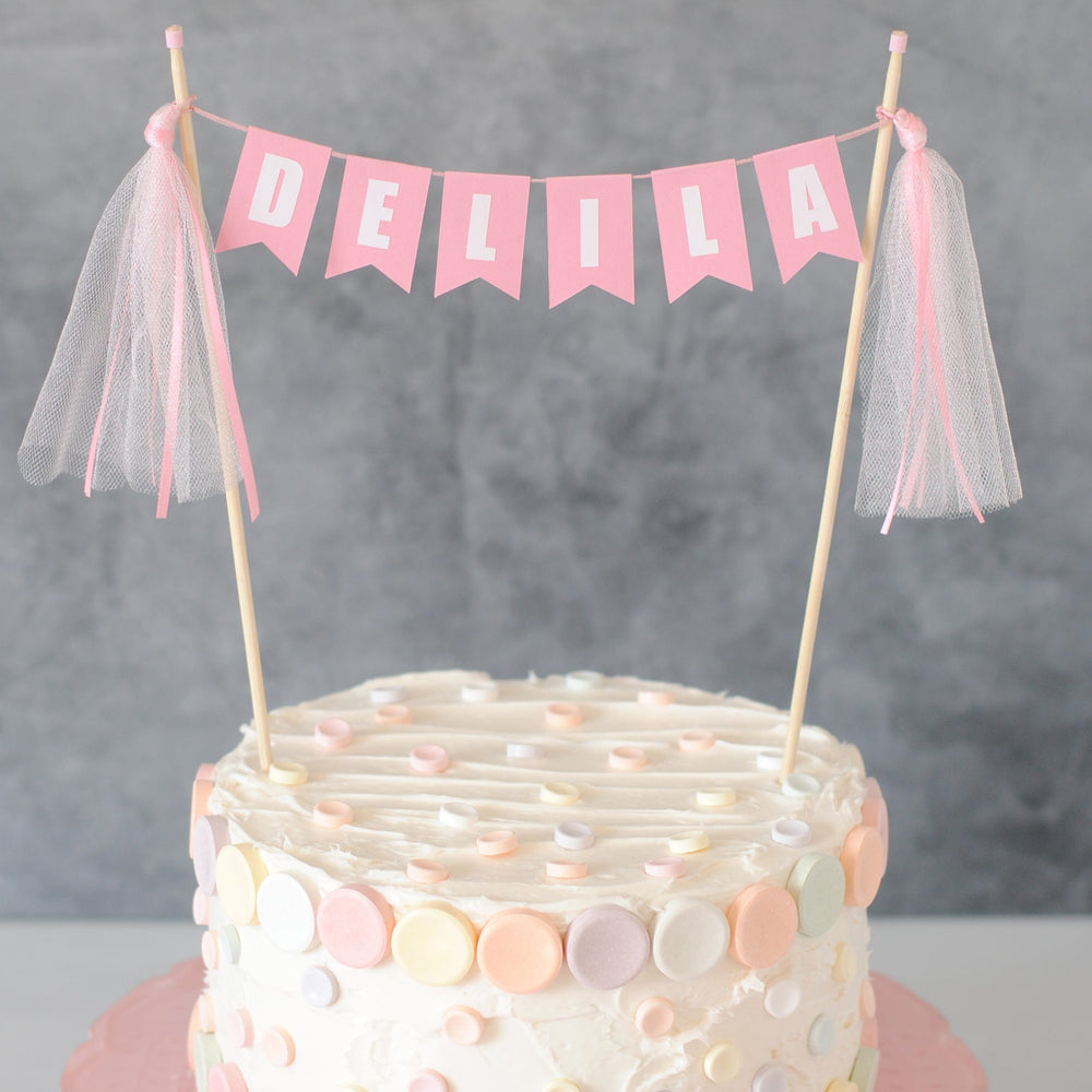 
                  
                    girls pink birthday cake banner personalized with name shown on a smarties birthday cake
                  
                
