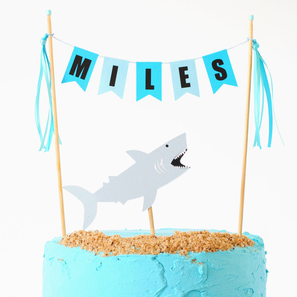 shark birthday cake topper set with name banner in shades of turquoise and a separate shark topper