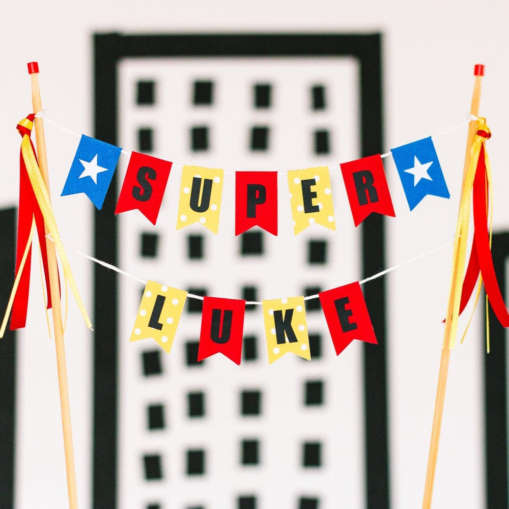 personalized super hero cake topper in red and yellow with blue and white stars