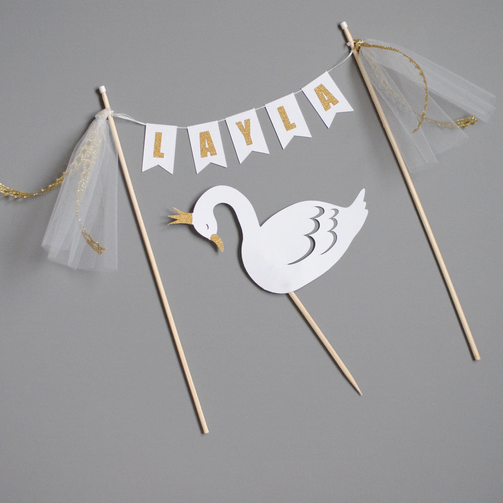 
                  
                    swan birthday cake topper set in white and gold
                  
                