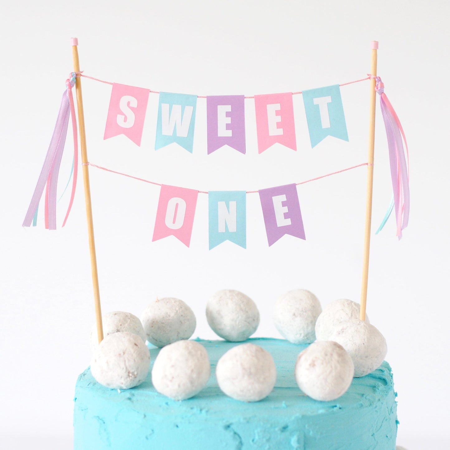 
                  
                    girls 1st birthday cake topper with wording SWEET ONE in pastel colors | cake topper made by Avalon Sunshine
                  
                